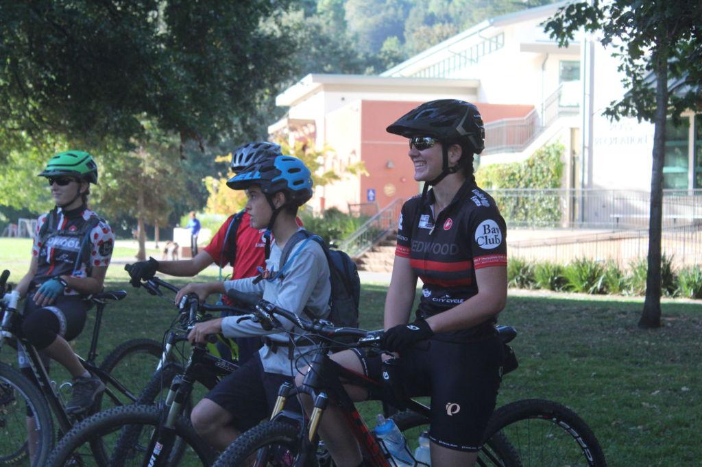 Preparing for her trail ride, junior Kate Benjamin sits up on her bike with fellow riders to her side.