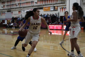 Running down the court, junior Gabby Beltran tries to keep the ball on Redwood's side.