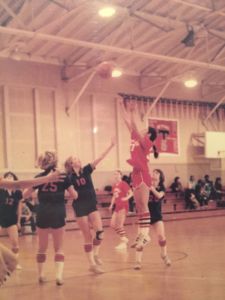 Shooting the ball during a game, Caren's picture sits in the Redwood Alumni Hall of Fame for her many athletic accomplishments.