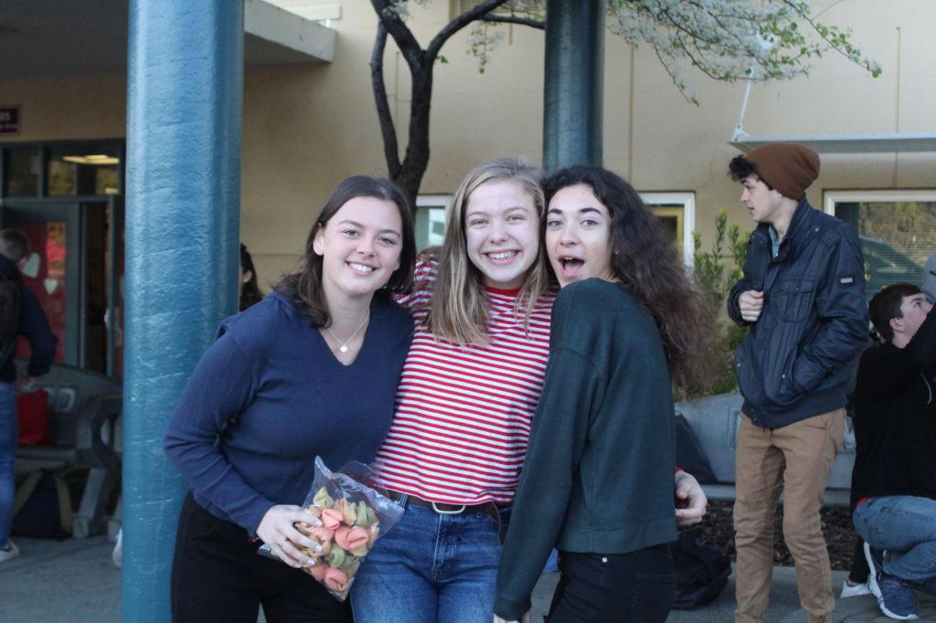 Senior Leadership students Luna Zirpoli, Amelia Shunk and Jacqueline Massey-Blake (from left to right) pose, ready to hand out fortune cookies.
