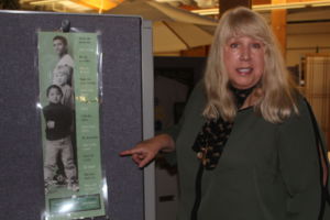 Pointing to a poster at the Center for Domestic Peace office, executive director Donna Garske explains how certain phrases that boys hear up growing causes of sense of toxic masculinity.
