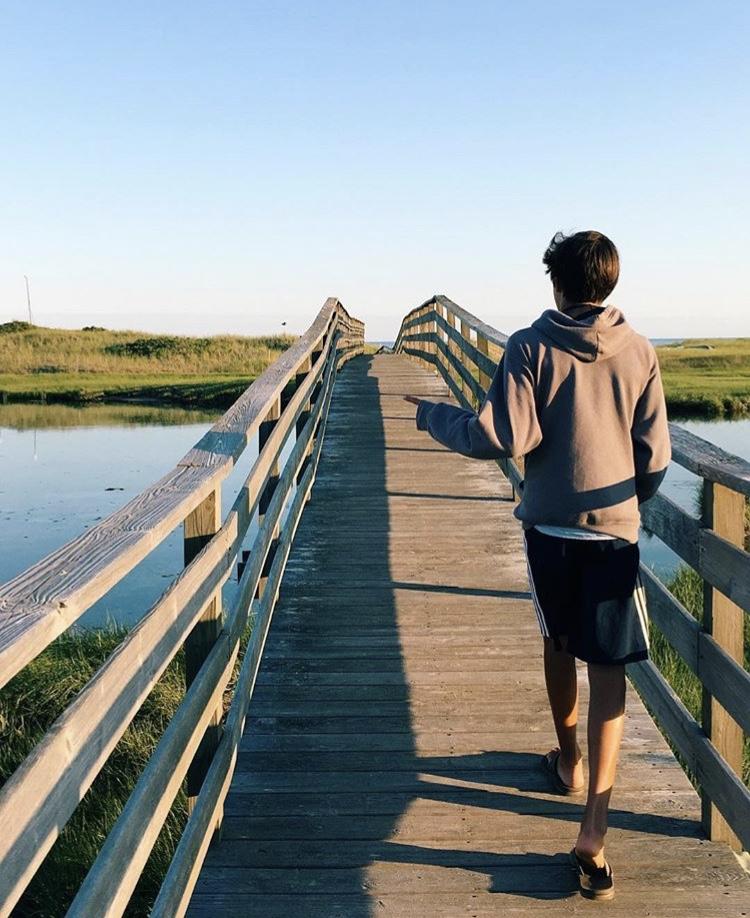 Walking across the bridge at Ridgevale Beach, Jackson Reed looks out at where his camp will soon take place.