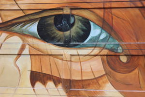 The horrors of war haunt many children, as this mural reminds viewers, and although the image is reflected in the child’s eyes temporarily, the memory will last forever.