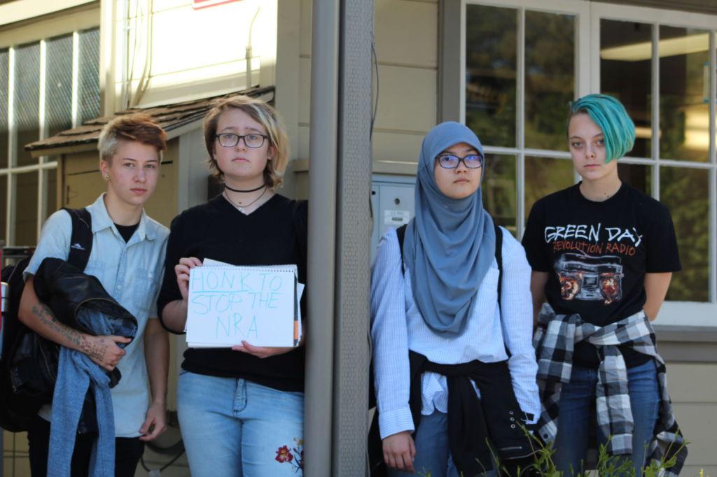  Holding up signs against gun control, a group of students participated in a walkout that ended at Larkspur City Hall.
