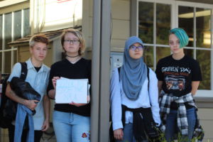  Holding up signs against gun control, a group of students participated in a walkout that ended at Larkspur City Hall. 
