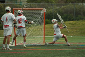 Junior goalie Talis Stockton reaches to block a shot made by SI.