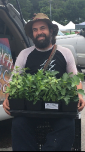 Avocado farmer Chris Krump holds his beloved plants
