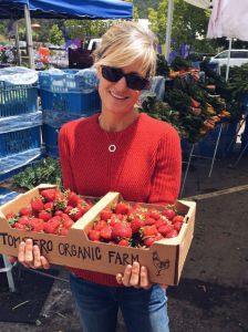 Leanne with some strawberries at the farmer's market