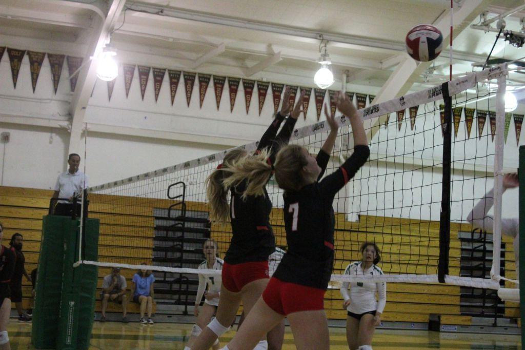 Brooke Leslie and Lucy Walsh, jumping to deflect the ball.