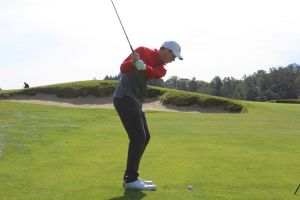 Solter in his backswing before chipping the ball on the green