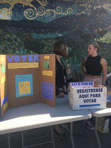 Informing potential voters, junior Olivia Raskin encourages fellow students to pre-register.