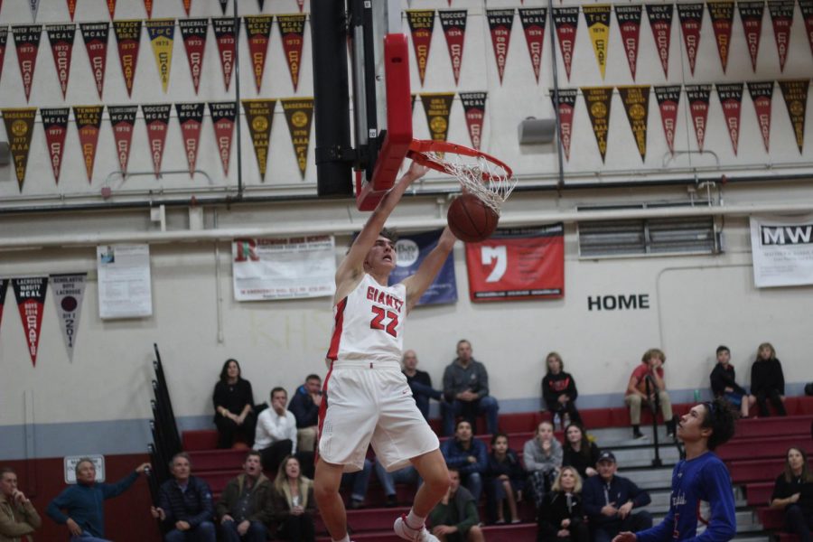 Brandon Radu throws a dunk against Tam High School.