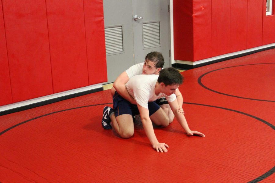 Junior team captain Michael Fitzsimmons practices his takedowns with his drill partner.