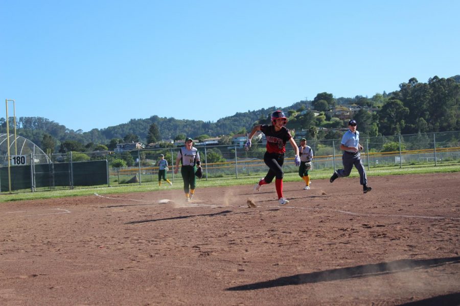Running along the the line,  Mia Hamant hits home base