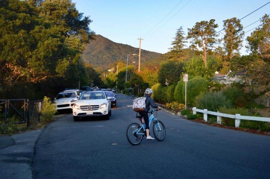 Middle schooler bikes across the busy corner of William from the exit of the Larkspur Corte Madera bike path. 