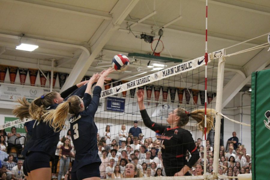 Redwood defender Grace Matthews (right) rises to a challenge from the Marin Catholic offense.