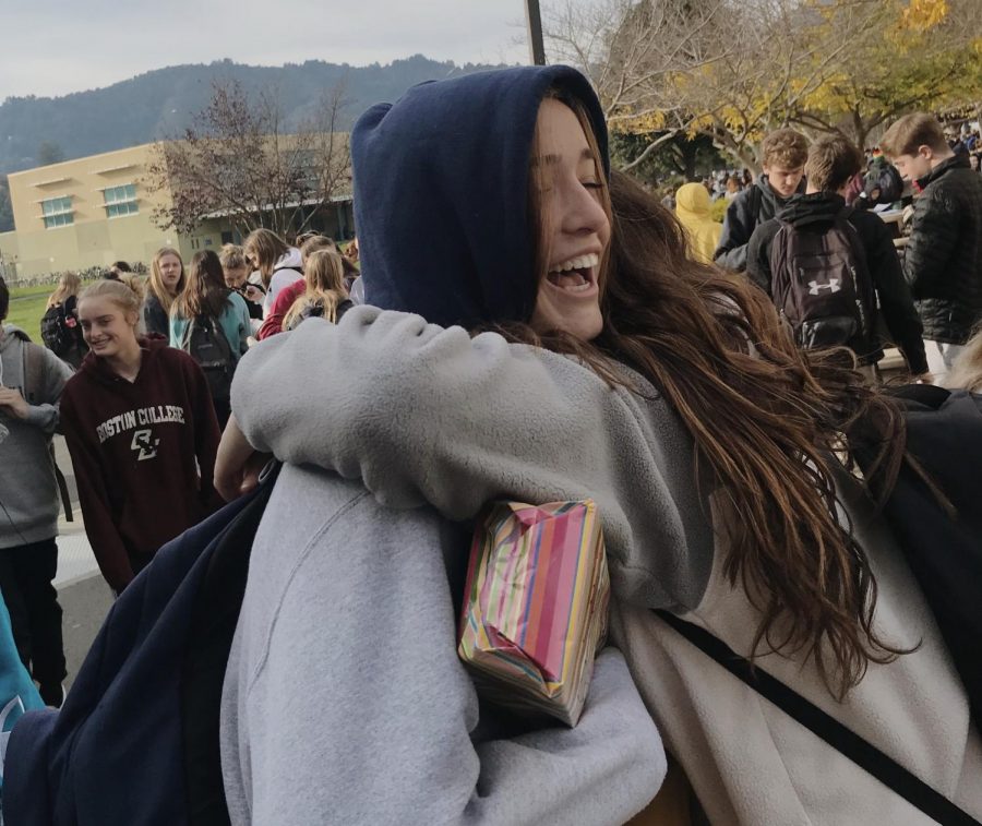 Students embrace and smile after completing their first final of the fall semester