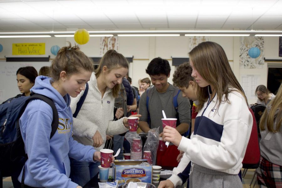 Helping themselves to hot chocolate and other seasonal snacks, students participate in annual Cocoa and Cram in preparation for finals.