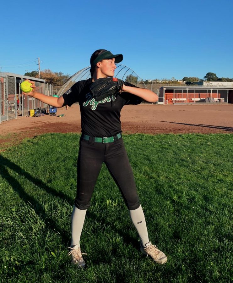 Junior Sadie Leonard throws the ball at her softball practice on Redwoods varsity field.