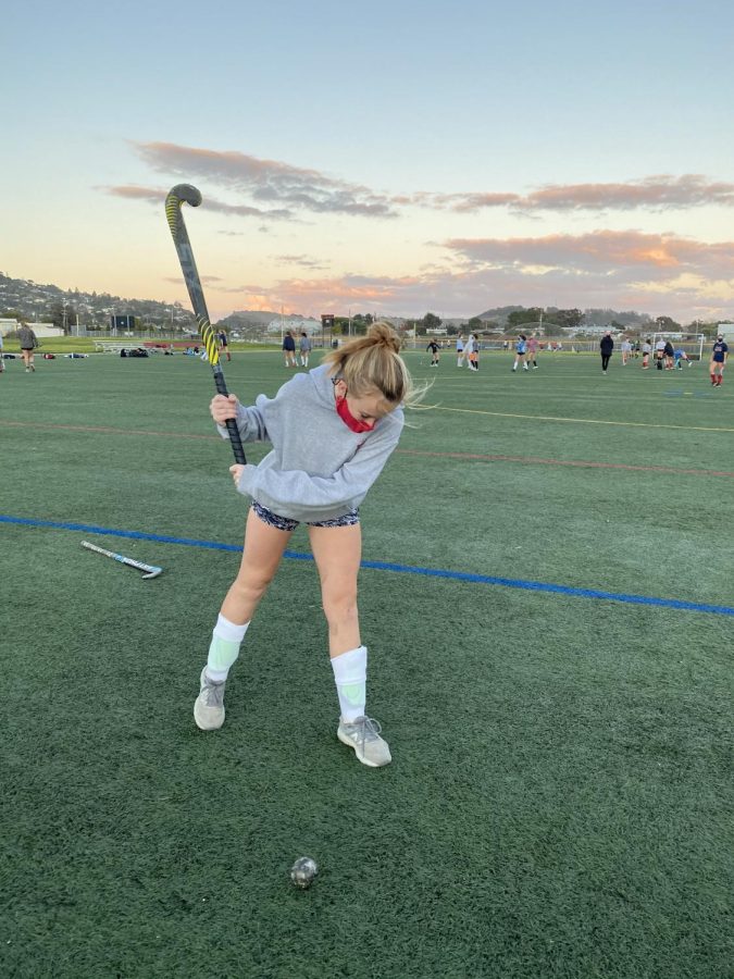 Winding up for a pass, junior Liv Holscher practices alongside her teammates for what should have been the field hockey teams first week of their Fall season. 