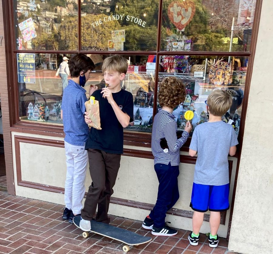 On a sunny day, a group of young boys gather outside of a candy store on Main Street in Tiburon to enjoy their sweets and their friends. 
