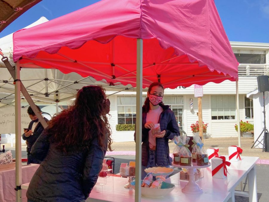 Junior Emily Sigel runs the Miette candy shop stand at the Marin Country Mart Saturday Farmer’s Market. 
