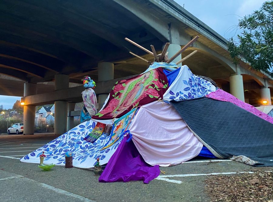 Sheltering from the rain, a homeless man sets up camp beneath Highway 101 in downtown San Rafael. 
