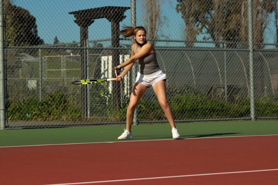 Senior Erin Roddy, ranked at the number two spot on the tennis ladder, pulls back her racket as she prepares to return a shot.
