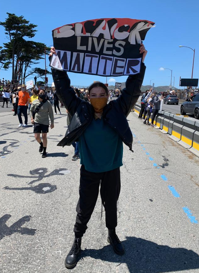 Attending a Black Lives Matter protest, Janneke Byck holds a sign up to show her frustration. Courtesy of Eliza Byck.   