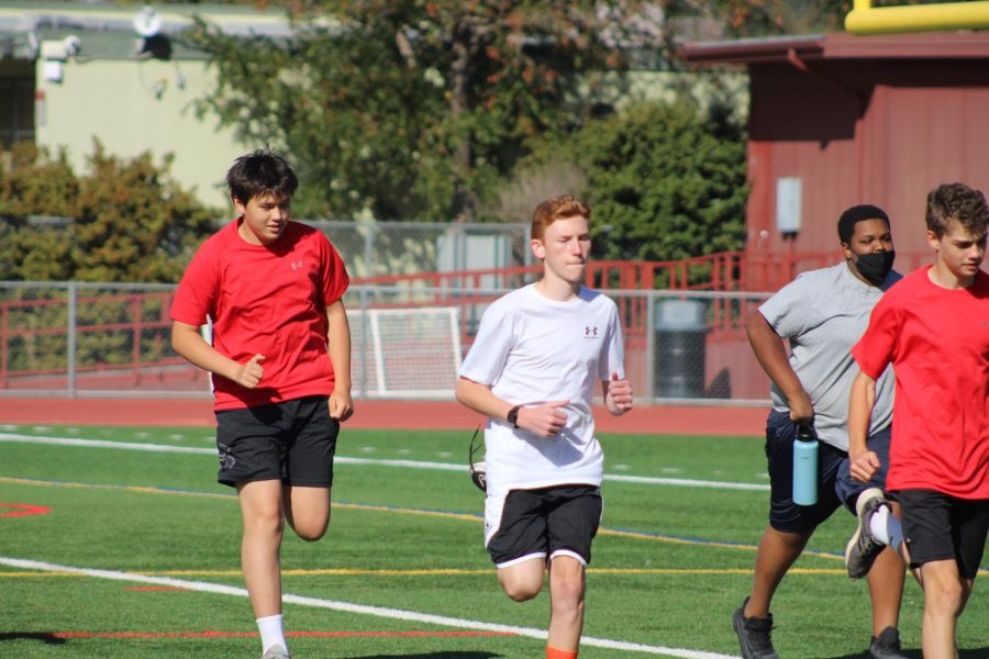 Warming up during PE, freshmen prepare to participate in the traditional Monday run-day.