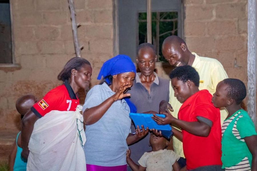 Celebrating, a family fills with excitement as they receive Wi-Fi and electricity for the first time. (Courtesy of James Kassaga Arinaitwe)
