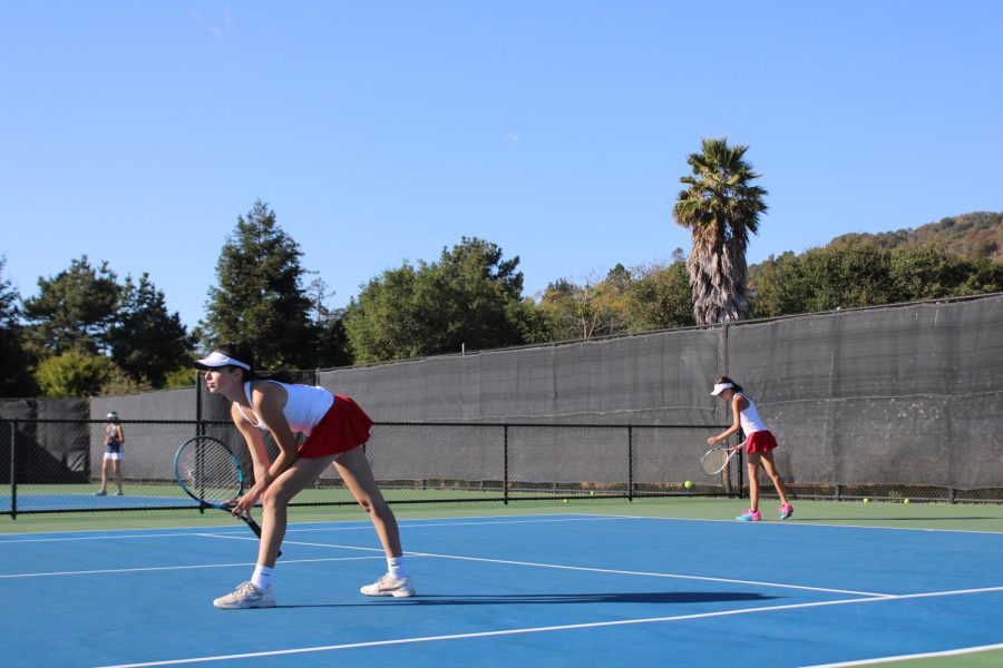 Preparing for the next point, doubles partners Isabella Kraus and Kate Tuhtan get in their stances.