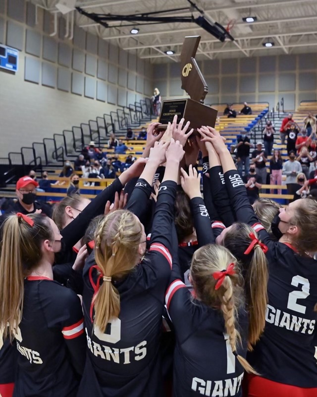 Hoisting the CIF Division II State championship trophy, the Redwood girls Varsity Volleyball team celebrates. (Courtesy of MaxPreps)

