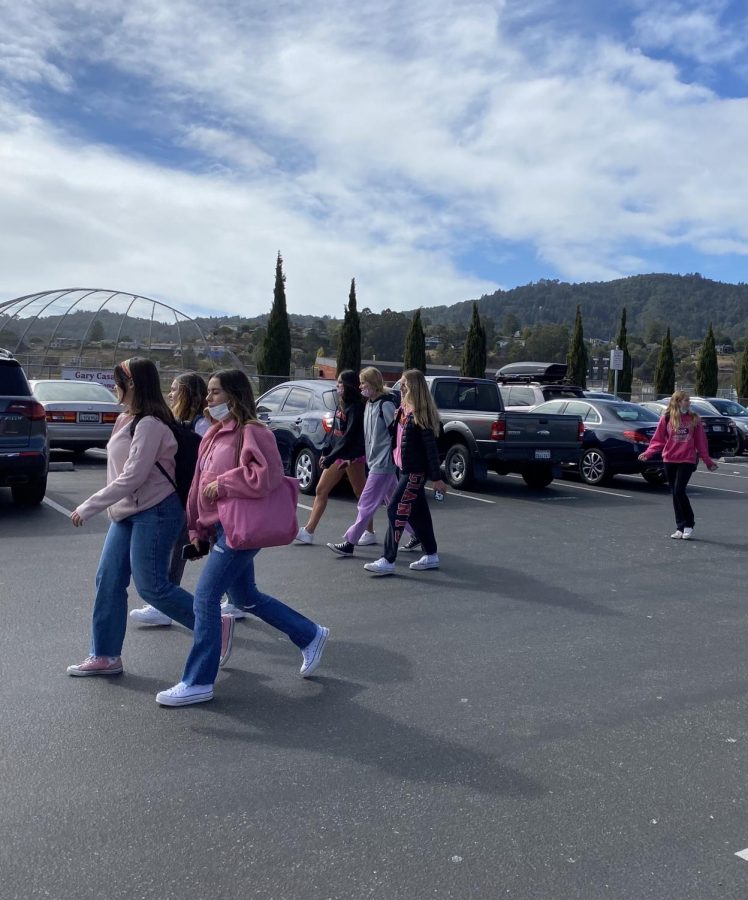 Walking to lunch decked out in pink, student show their support for Breast Cancer Awareness Month as well as school spirit.