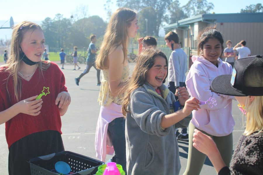 Blowing bubbles, Del Mar students bond with Peer Resource at their wellness event. 