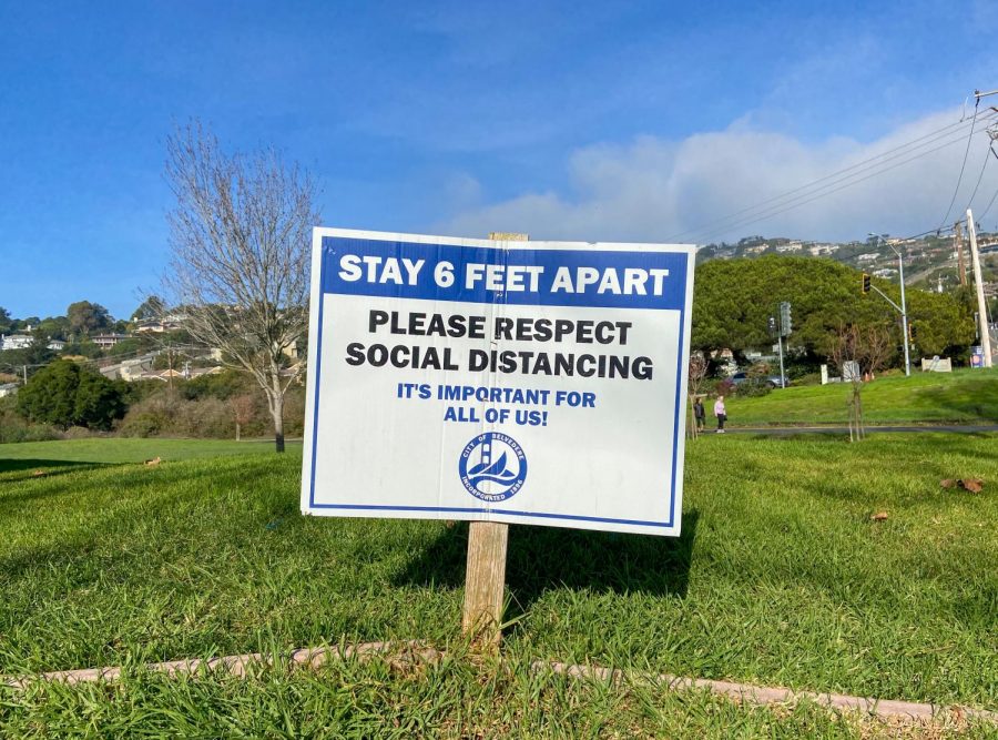 Reminding residents to stay six feet apart, a social distancing sign stands in a dog park in Belvedere, Tiburon.