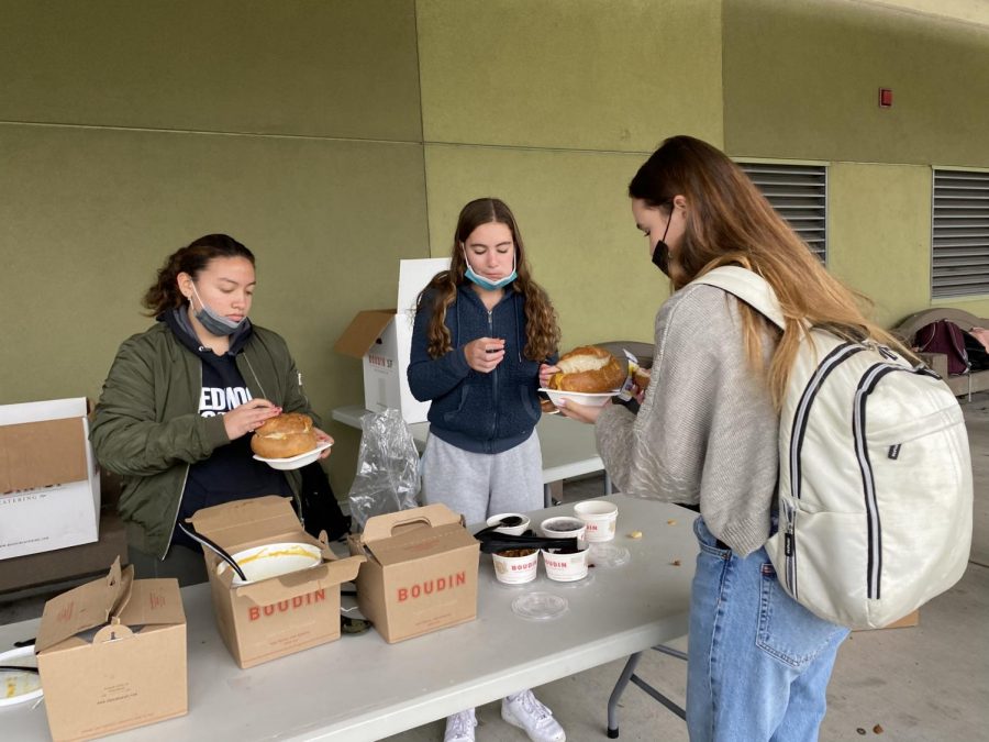 Purchasing Boudin bread bowls during lunch, students warm themselves on a cold day.