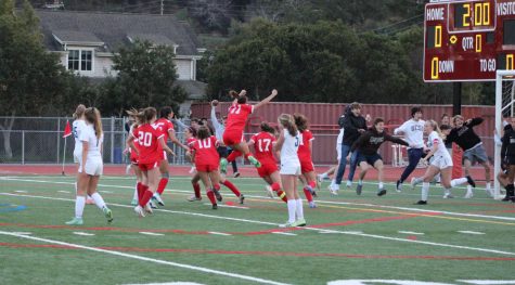 Celebrating an epic finish, the team and fans jump for joy after senior Sophia Pero passes the ball to Briana Salvetti, scoring the equalizing goal.