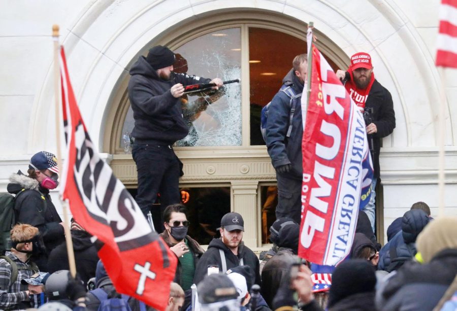 Shattering windows, insurrectionists break into the Capitol building on Jan. 6, 2021 in hopes of disrupting Biden’s upcoming inauguration. (Photo courtesy of CNBC)
