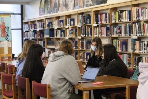 Settling in on their first week back from Winter break, students gather in the library to stay dry during lunch. 
