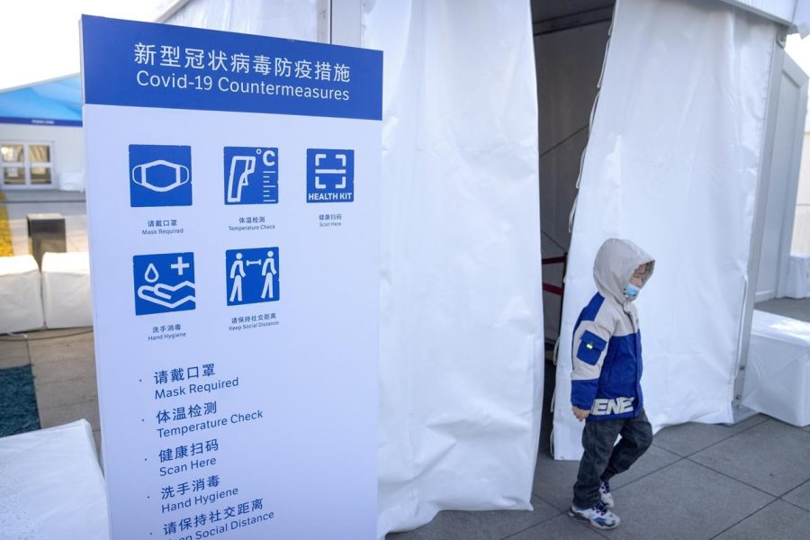Walking out of an Olympic screening area for spectators in Beijing, a child wears a face mask in compliance with Beijings strict countermeasures against COVID-19. 