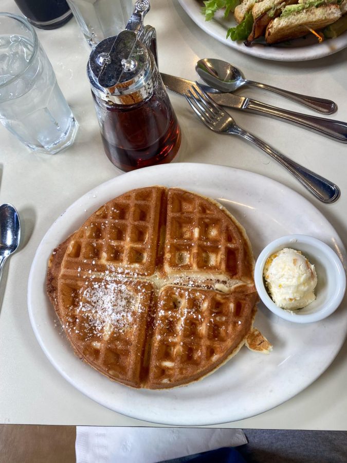 The Half Day Cafe plates its Belgian waffle with its signature orange butter.