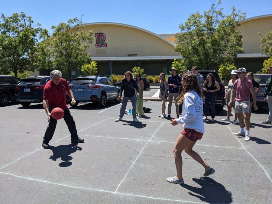 Principal David Sondheim hits the ball during a game of four square with seniors.