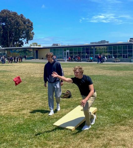 Playing cornhole on the south lawn, juniors Brody Guerro and Graham Guhm enjoy the final Friday Funday of the year. 