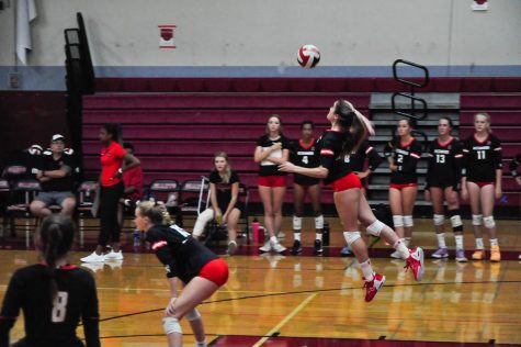 Girls Varsity Volleyball Captain Kaley Matthews launches a rocket across the court in the seasons first home game against Cardinal Newman High School.