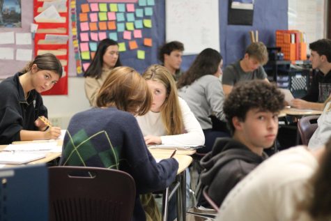 Studying at their desks, students work in cramped classrooms. Anna Royal Article