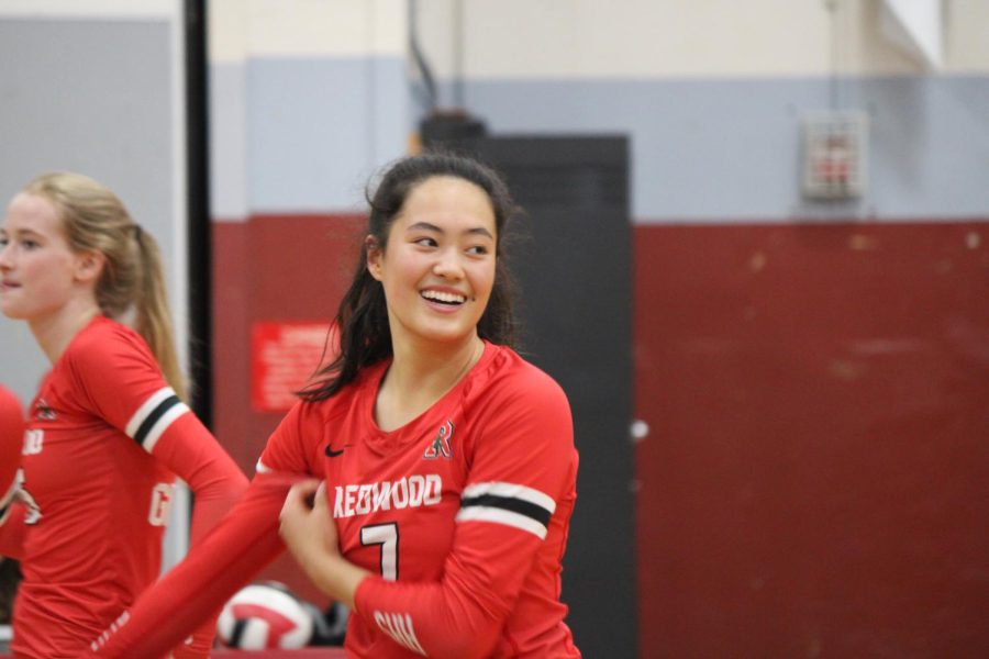 Smiling after an ace senior Kate Giang prepares for the next serve
