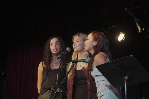 Vocalists Kraus, Emma Orrick and Belanger gather around the microphone to sing “Joy Spring” by Clifford Brown.

