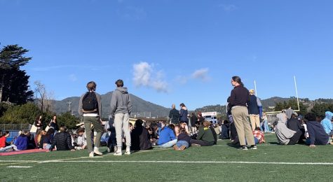 Sitting on the field, Tam students follow safety procedures on campus (Photo courtesy of Zoe Tokarski).