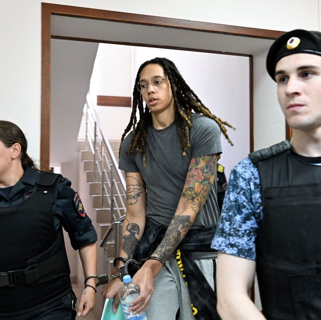 Arriving at a court hearing, Griner is photographed in handcuffs.